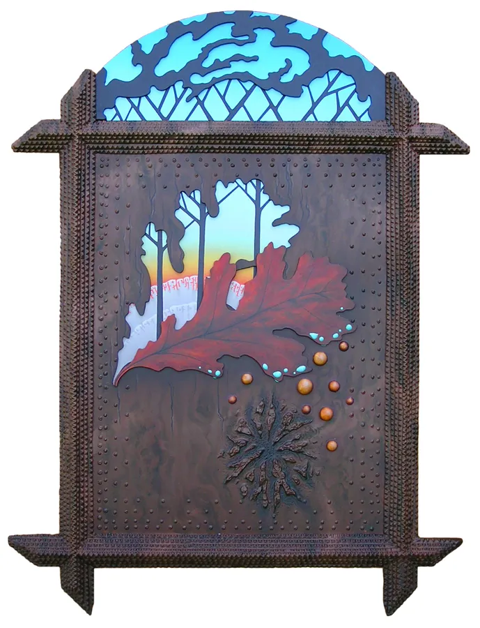 A red oak leaf and a cut-out woodland scene in a dark, studded wooden frame with an arched top.