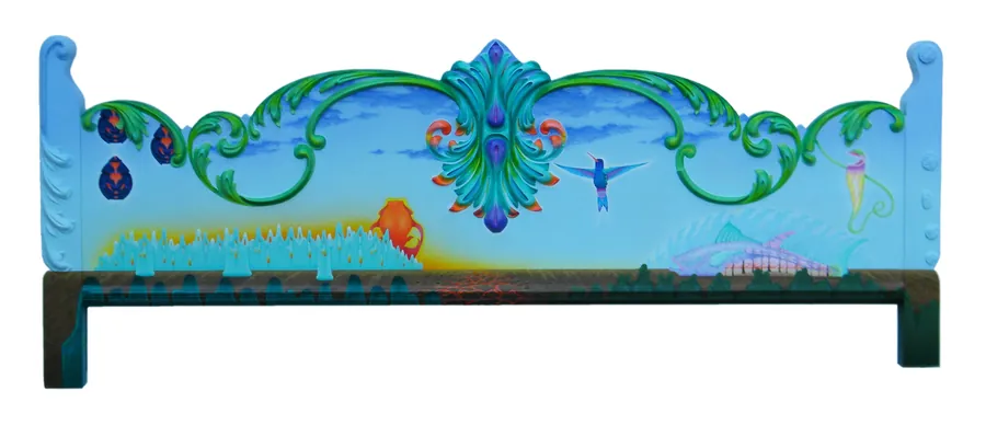A painted headboard: a blue landscape with a hummingbird beneath an ornate green crest.