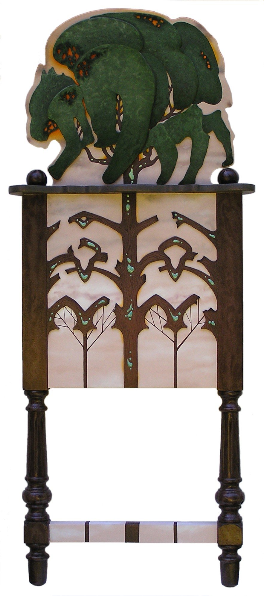 A painted cabinet on turned legs, topped by a carved green bison.